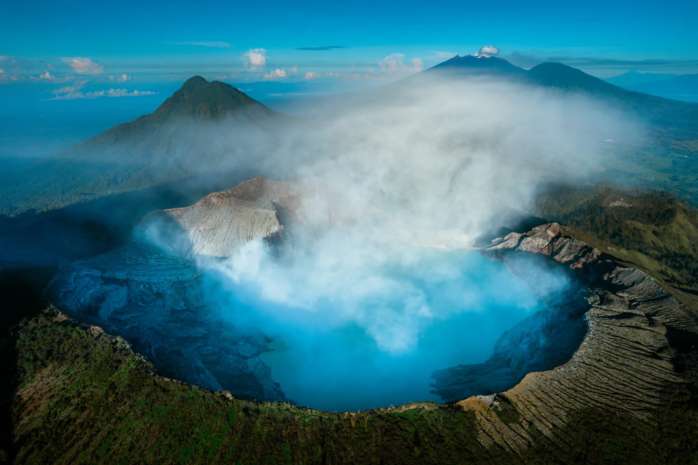 Aerial view of Kawah Ijen's turquoise crater lake at dawn