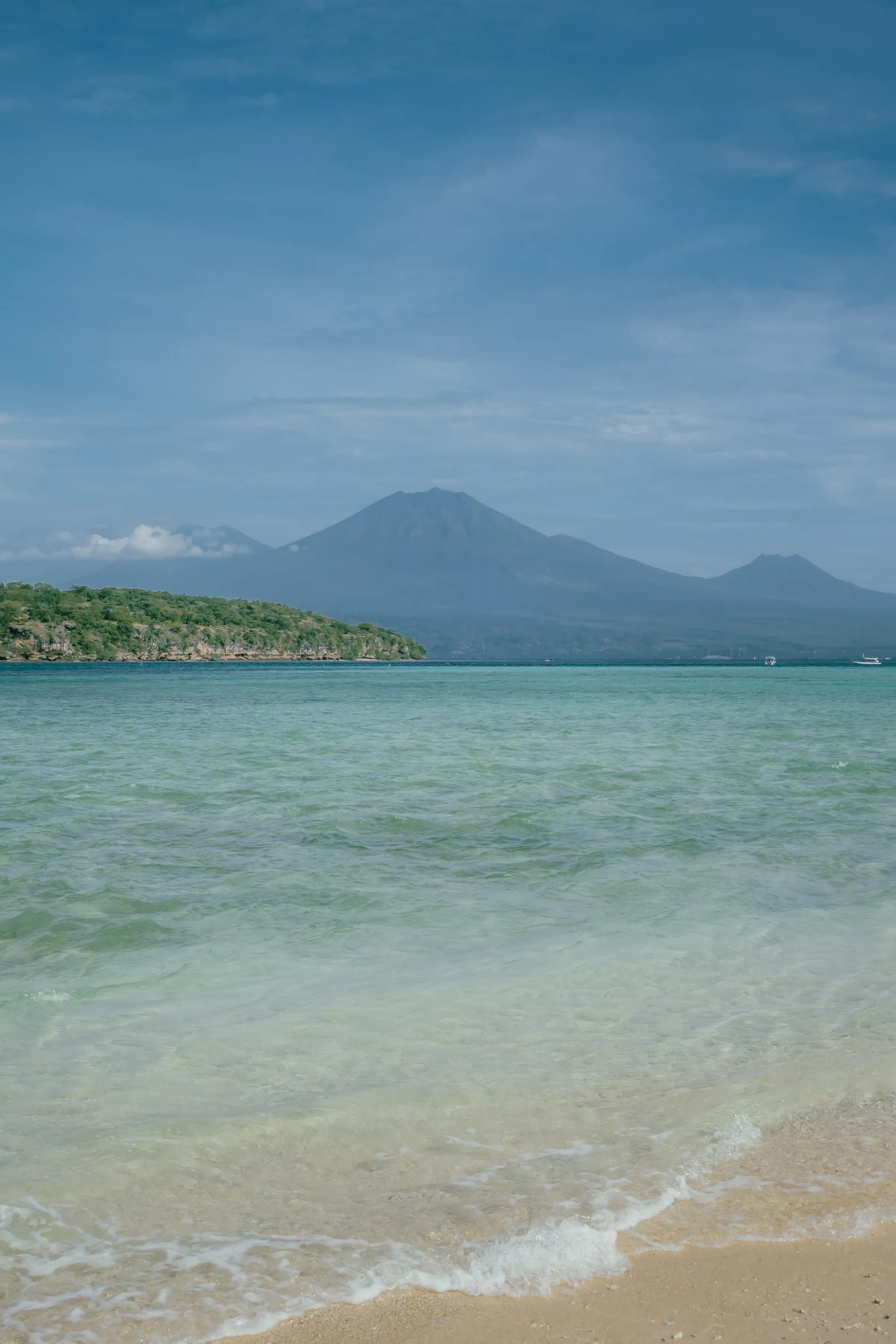 Calm turquoise shallows and mountain backdrop at Menjangan Island