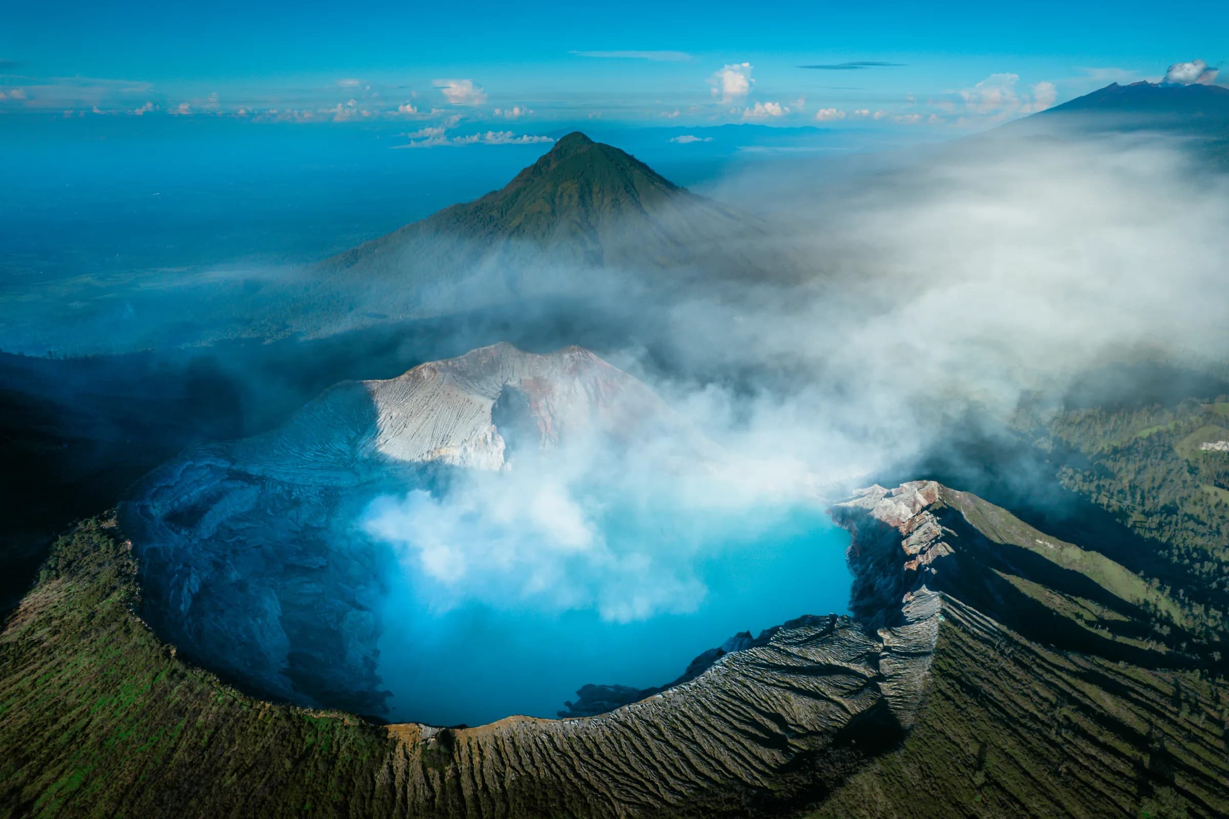 Kawah Ijen crater lake from above with surrounding volcanic cones