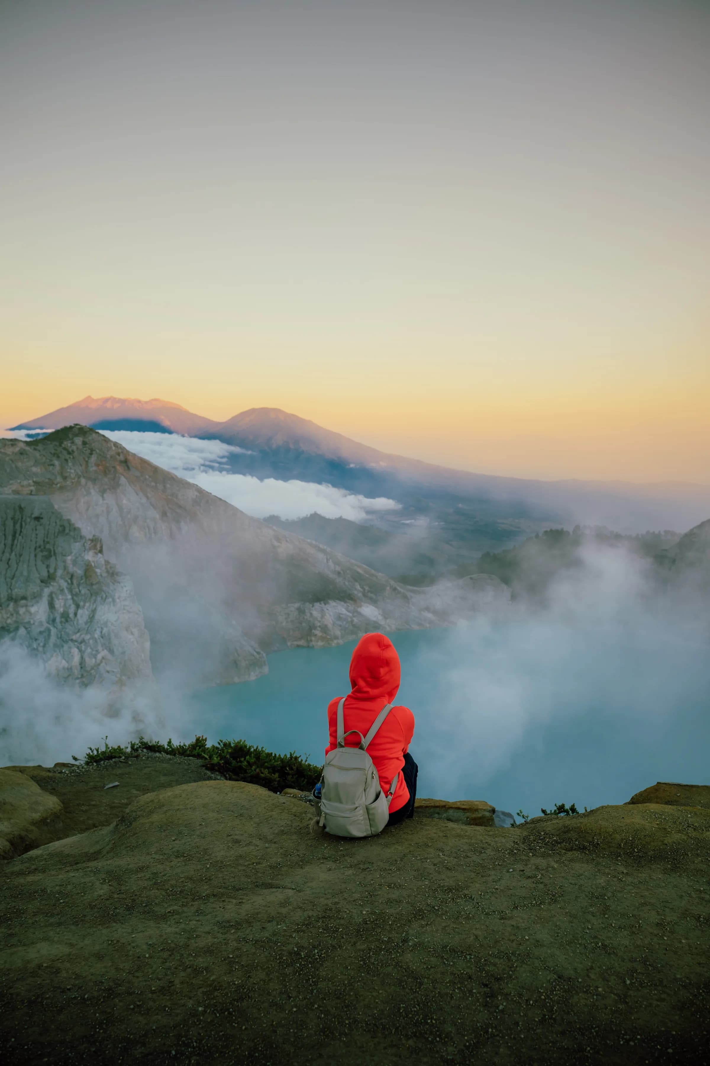 Trekker overlooking the Ijen crater at first light from the rim