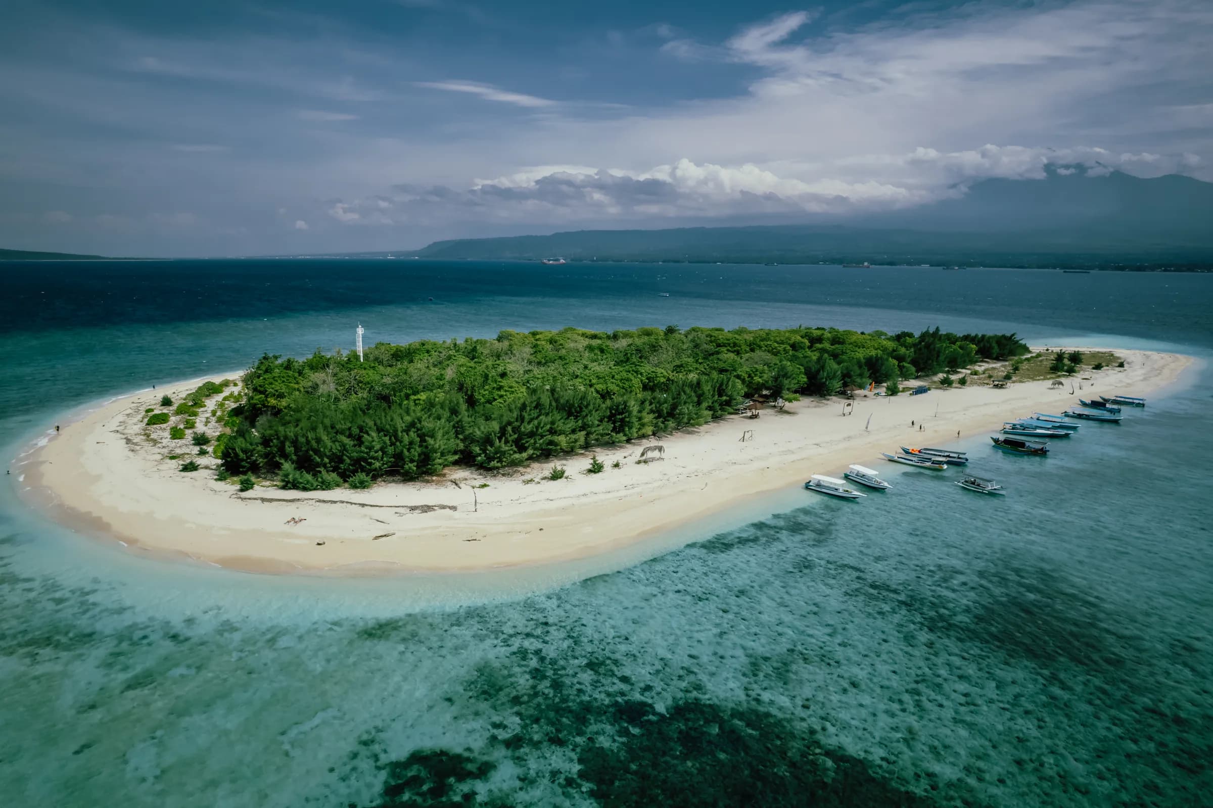 Aerial of Tabuhan Island, a teardrop sandbar ringed by turquoise shallows